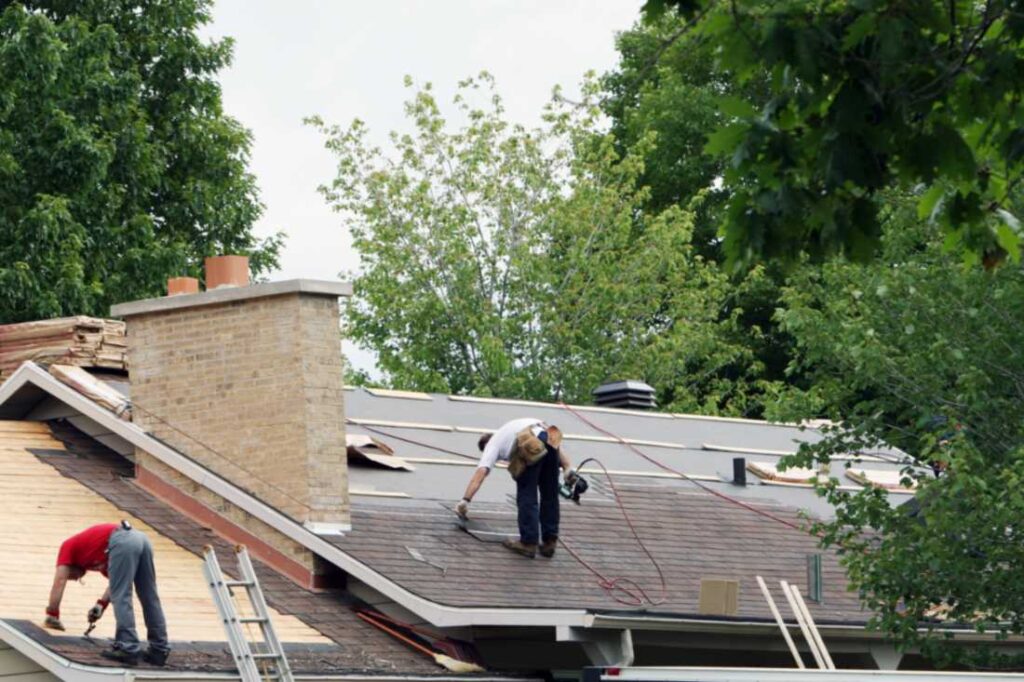 Workers installing a new roof on a house in Portland, OR
