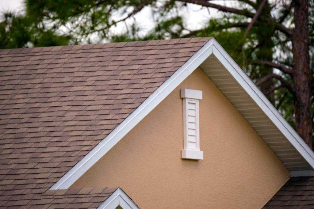 Cedar shake roof on a Portland home with weathered shingles, gable detail, and surrounding trees
